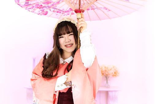 Japanese style lolita fashion woman holding a Japanese umbrella