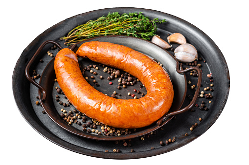 Smoked sausage with thyme and spices in a steel tray. Isolated on white background.  Top view