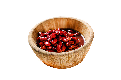 Red canned beans in a bamboo bowl.  Isolated on white background.  Top view.