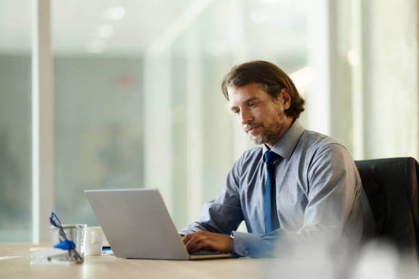istock Mid adult businessman working on a computer in the office. 2014900619