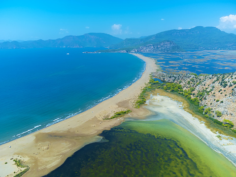 Loggerhead turtle spawning site Iztuzu Beach. It is known for its blue crab and golden sands. Next to Dalyan delta. Drone view from above valley of beach and mountains. Tourist place in Turzia.