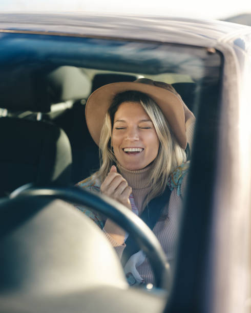 istock Carefree woman having fun in a car. 2014909834
