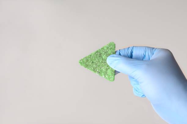 istock Gloved hand holding a salty tortilla chip. Concept for Salt Chip challenge. 2014916266