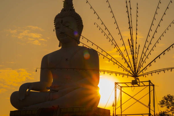 Sepia Image of Seated Buddha Image with Fantastic Sunbeams Radiating above Clouded Ocean in the Backdrop