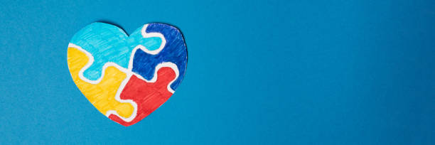 Banner. Colorful puzzle heart on a blue background