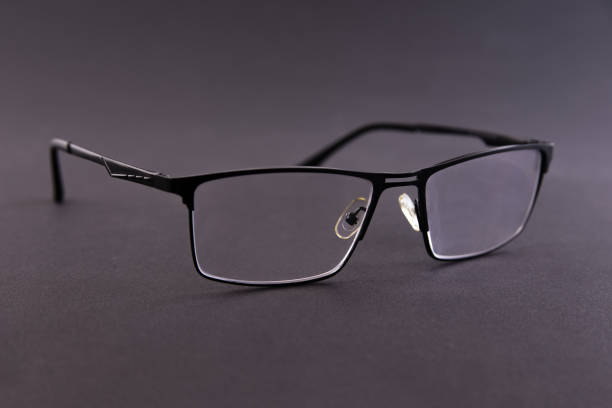 Black metal frame dioptric glasses on gray background