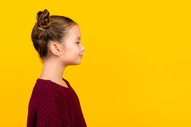 istock Profile portrait of positive nice schoolchild look empty space advert blank isolated on yellow color background 2014975497