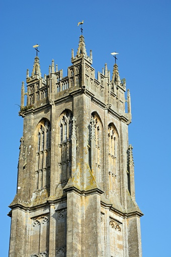 View of St John the Baptist church tower along High Street, Glastonbury, Somerset, UK, Europe.