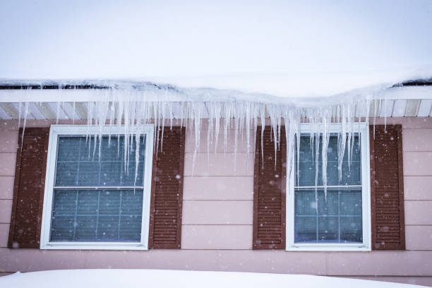 istock Ottawa, Canada - Icicles hanging on a snowy rooftop in front of two windows 2014977065