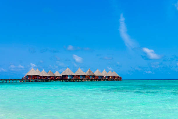 istock Over water villas on jetty in blue ocean 2014993468