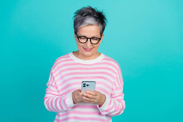 istock Photo of positive funny woman dressed pink pullover texting instagram twitter telegram facebook isolated teal color background 2015006315