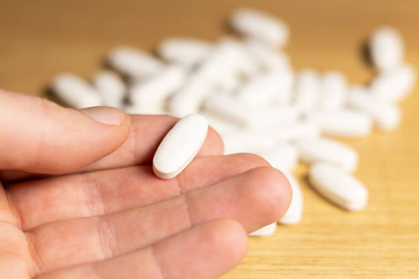 istock Man takes one capsules or pills. Healthy diet supplements. Microelements and vitamins for health care. 2015020539
