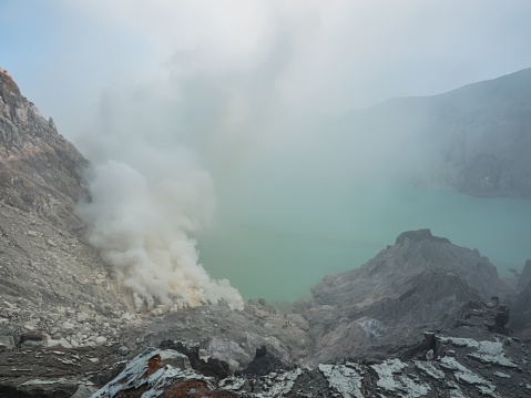 The lake full of natural Sulfuric acid and hydrogen sulfide gas inside the volcano carter at Kawah Ijen, East Java, Indonesia.