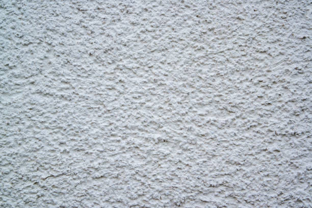 Textured plaster on a wall in the color white, texture background
