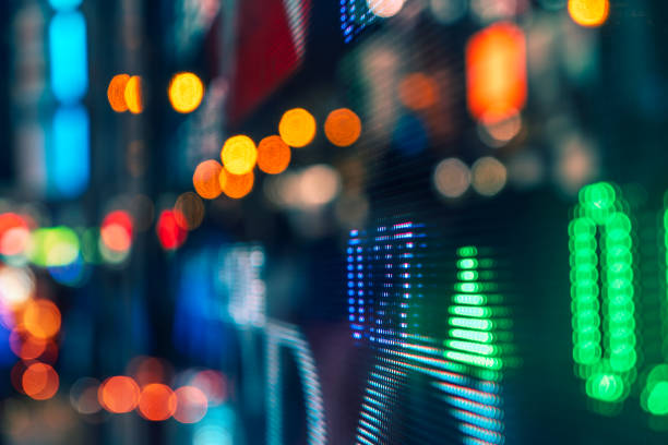 istock Blurred Urban Nightscape with Illuminated Digital Stock Ticker 2015032752