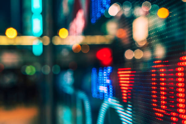 istock Blurred Urban Nightscape with Illuminated Digital Stock Ticker 2015033296