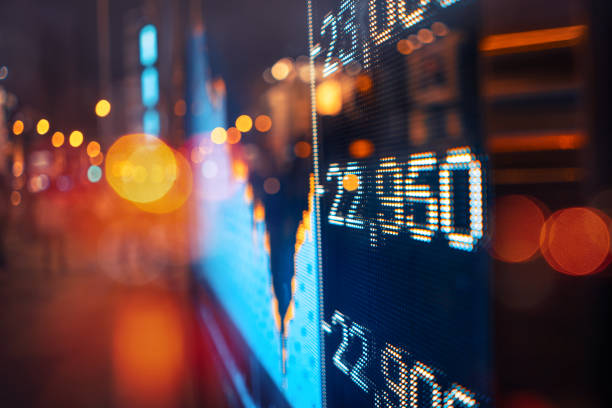 istock Blurred Urban Nightscape with Illuminated Digital Stock Ticker 2015033298