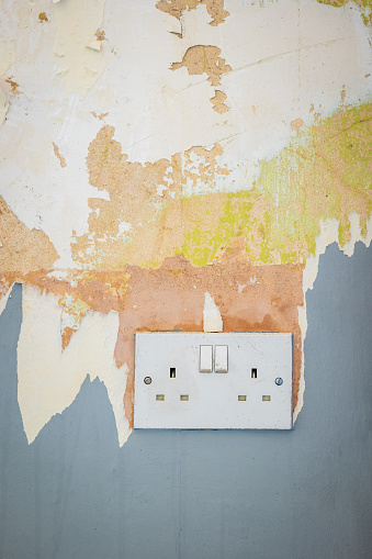 White plug socket closeup during room renovation in england uk.