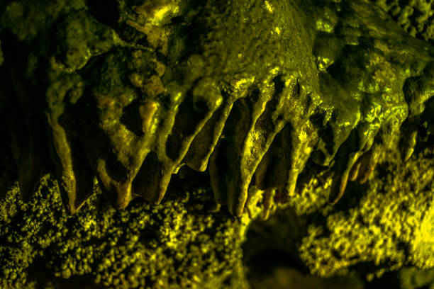Journey through a vibrant cave adorned with colorful walls, stalactites, and stalagmites, revealing the underground beauty of nature's geological wonders.