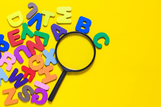 istock English letters scattered on yellow background. 2015037705