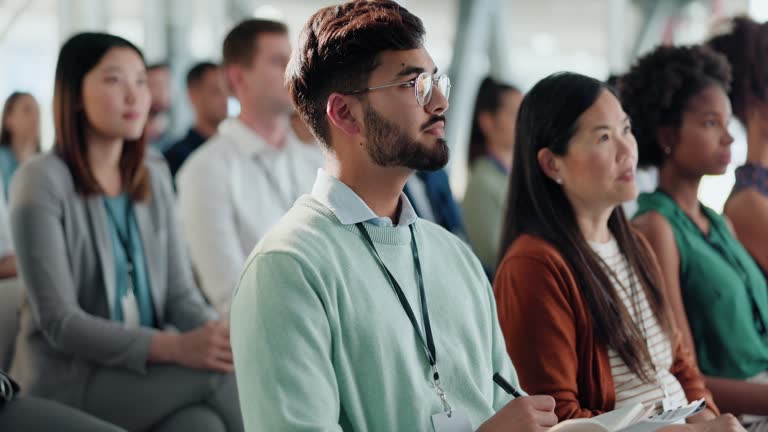 Conference, tradeshow and businessman in office with audience for company training in boardroom. Presentation, crowd and professional male person at corporate seminar or convention in workplace.