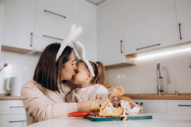 istock Little girl with her mother preparing Easter cake in kitchen 2015043203