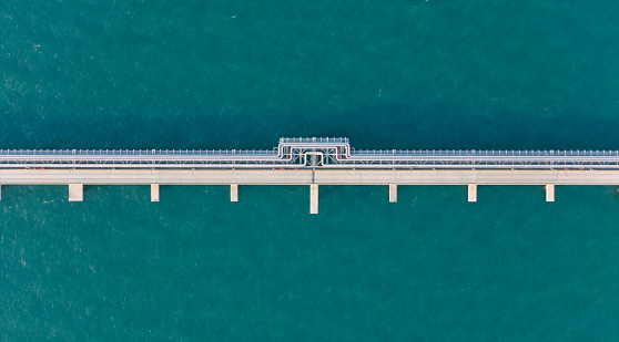 LPG,oil refinery, Logistics and transportation with working crane bridge in harbor