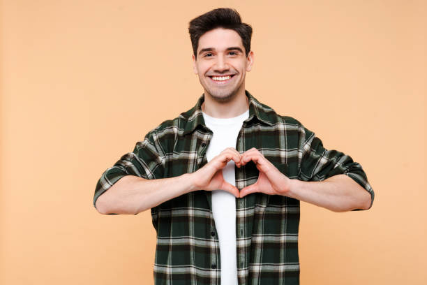 istock Happy man, overjoyed influencer man showing heart shape for subscribers isolated 2015076642