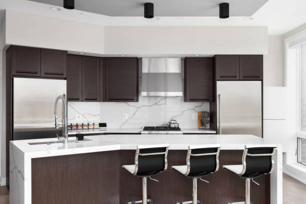 istock A modern kitchen with wood cabinets and marble countertops. 2015077182