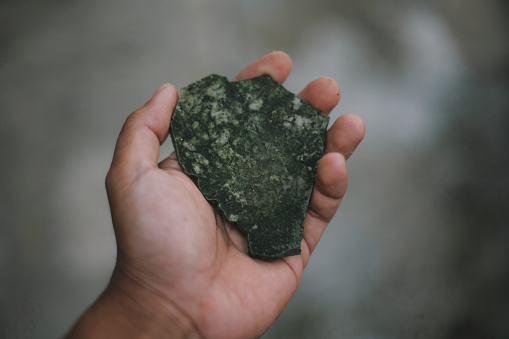 green rock in hand