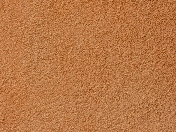 istock Textured plaster on a wall in the color orange, texture background 2015085511