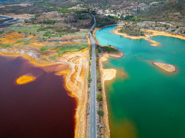 Aerial drone view of Mining activity in Minas de Riotinto in Spain. Apocalypse scenery. Mining village in Andalusia. Earth destruction. Disruption of nature. Extracting natural resources from the Earth to sell on the world market. Ecological disaster. Climate change. Water and river pollution. vista aérea con dron de la actividad minera en minas de riotinto en españa. escenario apocalíptico. destrucción de la tierra. alteración de la naturaleza. extraer recursos naturales de la tierra para venderlos en el mercado mundial. desastre ecológic