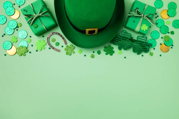 istock Saint Patrick Day background with green decoration from shamrocks, leprechaun hat, golden coins and gifts top view. 2015138052