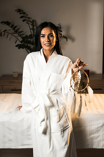 Young woman in a bathrobe posing in a massage room.Spa and massage concept