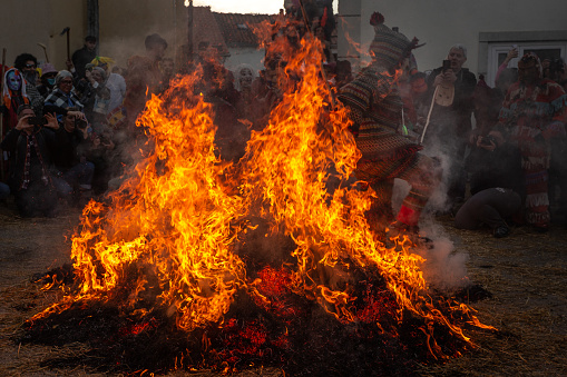 13 February 2024, Mascaraed People jumping cross bonfires in an ancient tradition of Carnival in Vila Boa de Ousilhão, Bragança, Portugal.