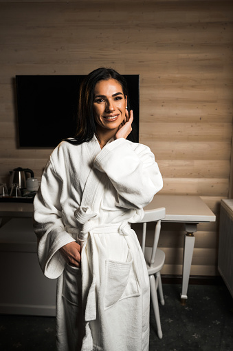 Young woman in a bathrobe posing in a massage room.Spa and massage concept