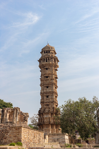 Chittorgarh, Rajasthan, India - November 4th 2023: The famous victory stand or vijaya stambha of Chittorgarh Fort standing high on clear blue sky
