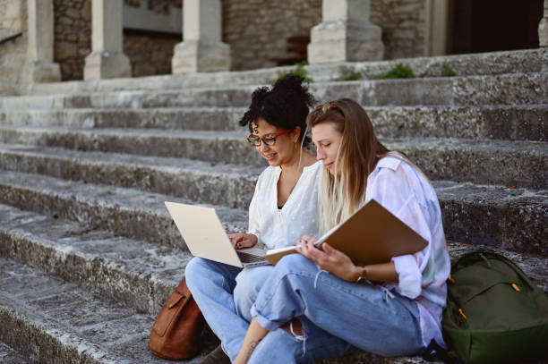 istock University students in a campus sitting on stairs and preparing for exams. 2015186535