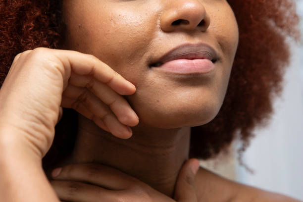 istock Woman's hand touching the side of her face 2015199609