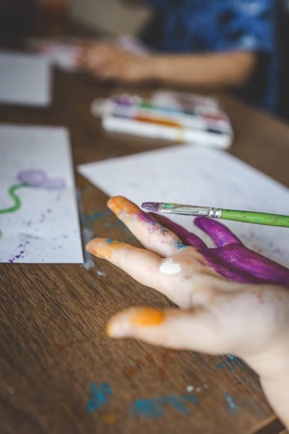 istock Children's drawing workshop, happy children make handprints with paint 2015200136