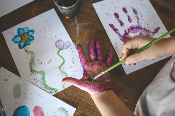istock Children's drawing workshop, happy children make handprints with paint 2015200139