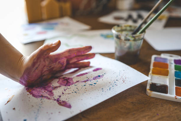 istock Children's drawing workshop, happy children make handprints with paint 2015200140
