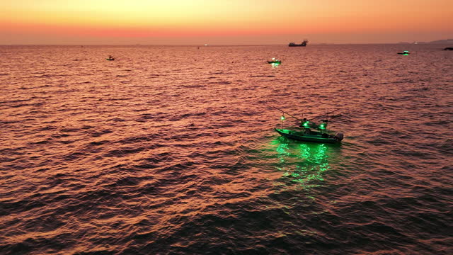 Squid fishing boat Turn on the squid lure light after sunset. Fishing boat go to ocean for catching fish all a long night  Thailand. Top view of Fishing Boat