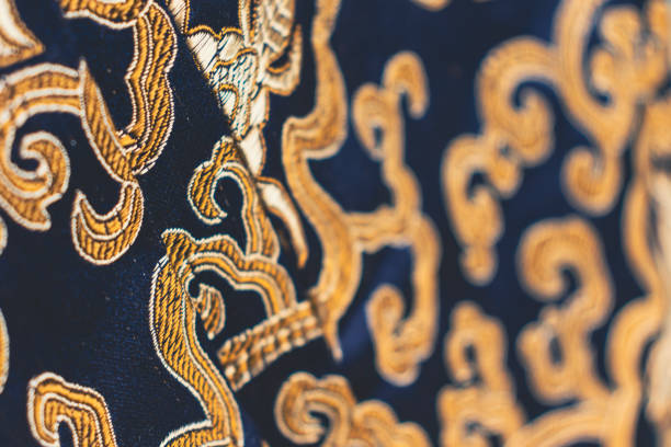 istock Close up of a deep blue and gold brocade fabric. 2015222567