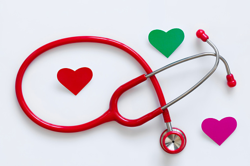 Medical stethoscope and three heart on the white background.