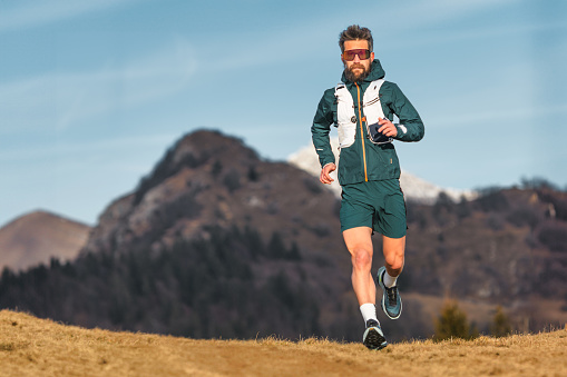 Ultramarathon man runner during a workout in the hill