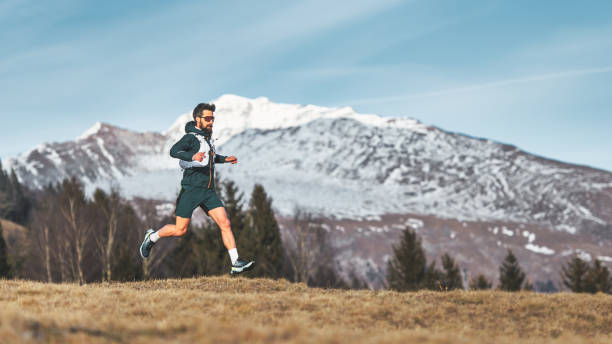 A skyrunner athlete man run in the high mountains