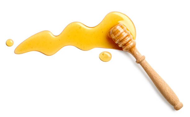 istock Honey splash with wooden honey dipper on white background 2015274554