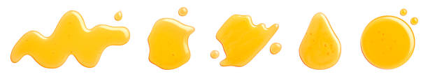 Set of various yellow honey spill, splash and drops isolated on white background, top view