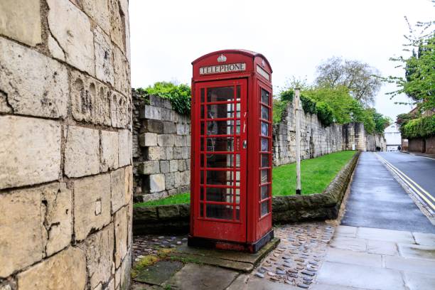 istock A Classic Red Telephone Booth Amidst Historical Stone Walls 2015280043